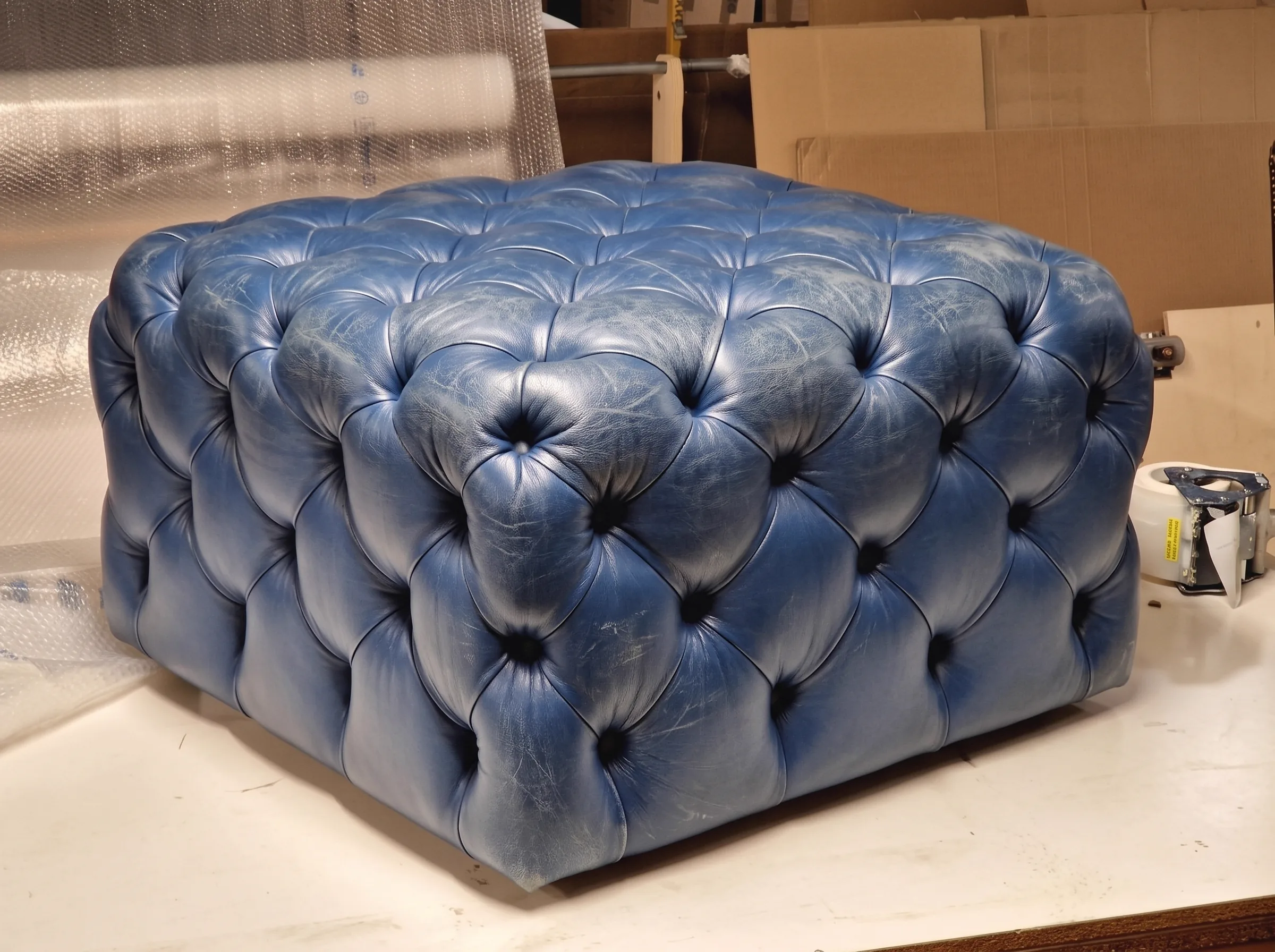 Darkened, worn brown leather sofa before restoration